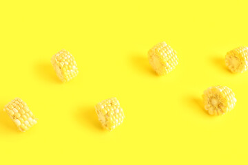 Cut fresh corn cob on yellow background