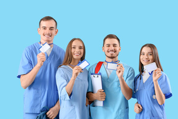 Group of medical students with badges on blue background