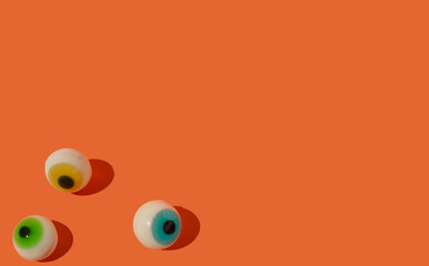 Jelly eyeballs on orange background. Halloween concept