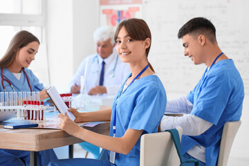 Female medical student with notebook at lecture