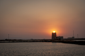 Obraz premium Sunset Over the Tower by the Sea 