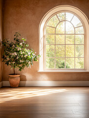 Bright sunlight streams through a large window illuminating a serene room with a potted plant and warm wooden flooring