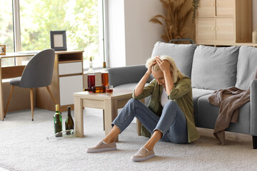 Drunk mature woman at home. Concept of alcoholism