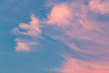 Pink clouds against blue sky