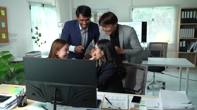 Four enthusiastic business colleagues are happily congratulating a businesswoman on her achievements and promotion, creating a positive and supportive work environment
