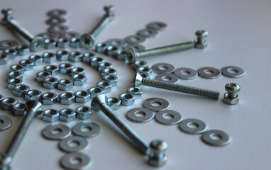 Nuts, Washers And Bolts Arranged In Star Pattern On White Surface Angle View 
