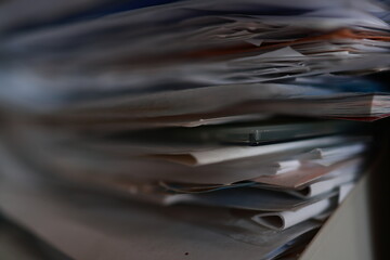 Stack of magazines, books, papers in the office.