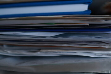 Stack of magazines, books, papers in the office.