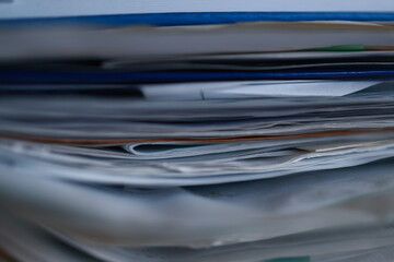 Stack of magazines, books, papers in the office.
