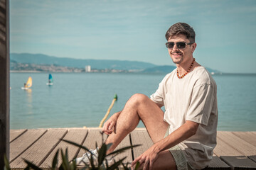 summer holidays and people concept ,portrait of young man in sunglasses on beach