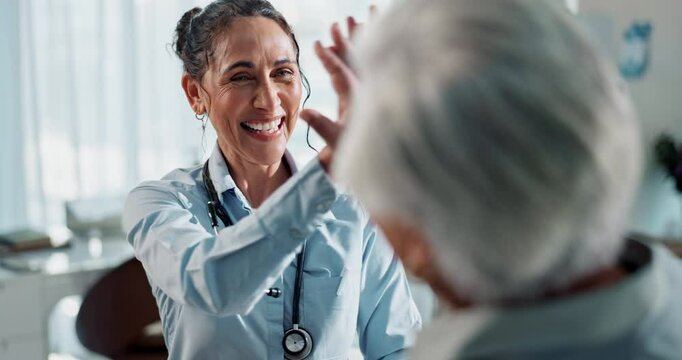 Happy woman, high five and elderly care with patient for consultation, advice or teamwork at hospital. Female person, medical employee and senior with success for healthcare support, trust or help