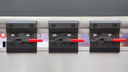Obraz premium Three swivel clamps for bending tools and equipment.