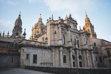 Fototapeta premium The baroque facade of the cathedral of santiago de compostela, bathed in the golden light of the setting sun
