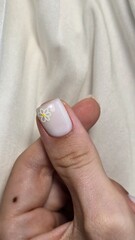 The beauty of the natural nails. Perfect clean manicure. New trendy nail arts on young women hand. Beautiful nail polish in hand