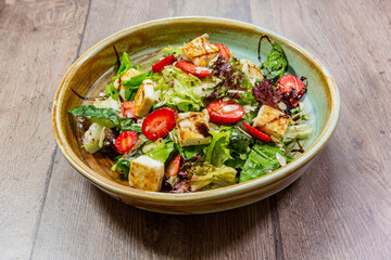 delicious fresh salad. salad with tomatoes, cucumbers and other vegetables with toasted bread and looking great.