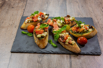 bruschetta with fresh vegetables and fresh meat. 