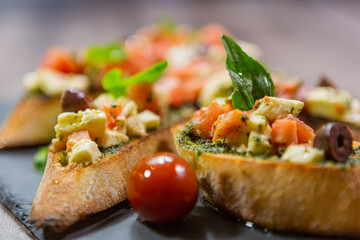 bruschetta with fresh vegetables and fresh meat. 