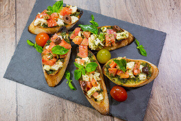 bruschetta with fresh vegetables and fresh meat. 