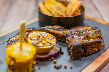 juicy steak with potatoes and corn. well done grilled meat. fresh meat dish with vegetable garnish.