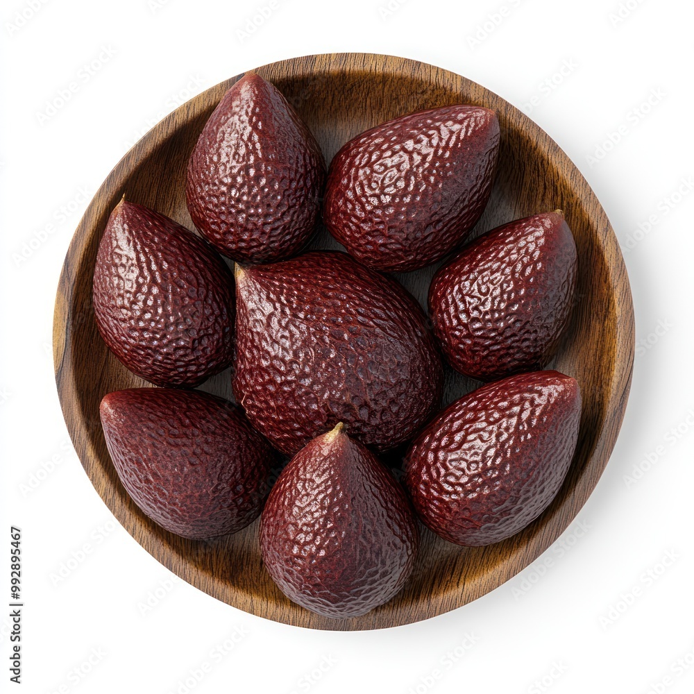 Canvas Prints A wooden bowl filled with ripe, dark red avocados arranged neatly.