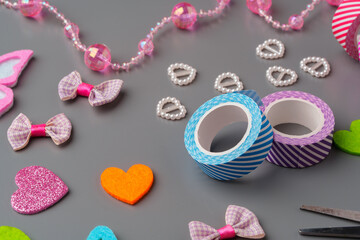 Crafting materials and tools arranged on a gray surface during a creative project