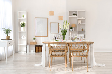 Stylish table setting with vase of Gladiolus flowers in kitchen