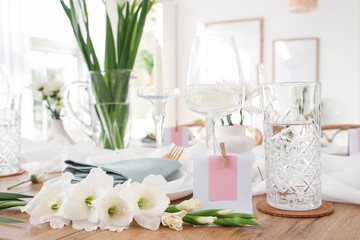 Stylish table setting with vase of Gladiolus flowers in kitchen