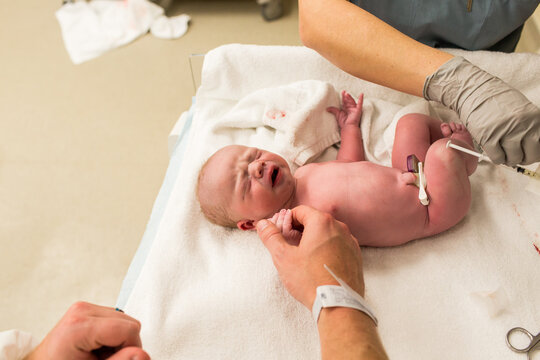 Newborn Baby Holds Dad's Hand While Getting Vaccinations