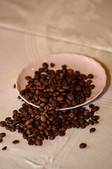 A pile of coffee beans spilled on the table