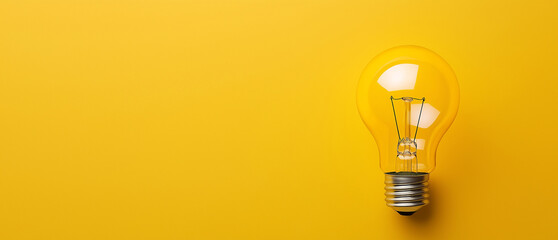 Bright Idea: Yellow Light Bulb. A single yellow light bulb on a vibrant yellow background symbolizes innovation, creativity, and illumination. Perfect for concepts related to ideas and inspiration.