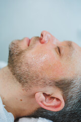 Obraz premium Male cosmetology in a beauty salon. A man takes care of his facial skin.