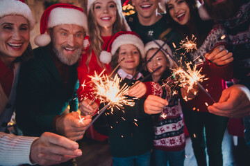 Cropped portrait of friendly peaceful family bengal lights gather celebrate new year xmas flat...