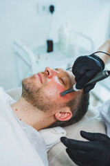 Fototapeta premium Male cosmetology in a beauty salon. A man takes care of his facial skin.