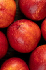 a large number of ripe soft nectarine fruits on the table