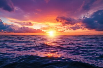 Fototapeta premium Colorful sunset over the ocean, with the vibrant sky reflecting in the water