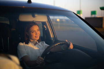 positive woman driver driving a car