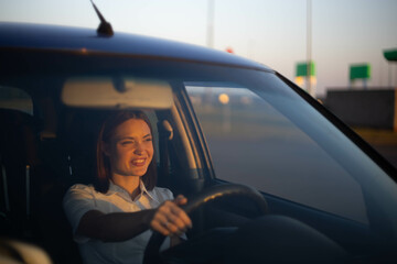positive woman driver driving a car