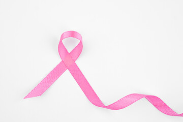 Pink ribbon symbol for breast cancer awareness on a plain background