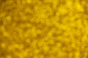 Shiny gold glitter background, blurry sparkling lights texture, perfect for backgrounds, textiles,...