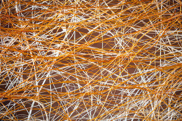 Natural background, texture, interweaving of beige and orange shrub fibers