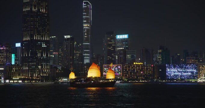 Hong Kong Victorial Harbour Traditonal Red Sailing Junk Boat Nightview of Tsim Sha Tsui Skyscrapers with City Lights