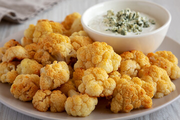 Homemade Buffalo Cauliflower with Blue Cheese Sauce, side view.