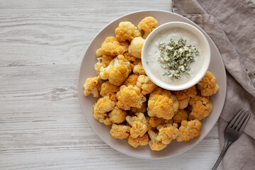 Homemade Buffalo Cauliflower with Blue Cheese Sauce, top view. Copy space.