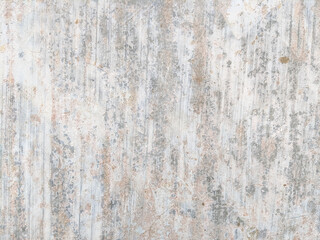 Weathered surface with vertical streaks and faded spots in light gray and beige tones. The textured wall showcases signs of aging, roughness, and subtle color variations in an abstract pattern.