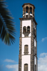 A tall colonial tower with a clock on it