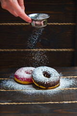 sprinkle donuts with powdered sugar