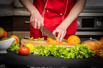 person cutting vegetables in kitchen
