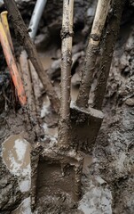 Fototapeta premium Detailed view of mud caked tools and equipment used in flood recovery, highlighting the grit and effort involved
