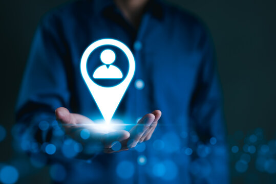 Targeted Marketing and Customer Strategy Concept. A person holds icon of a location marker with user symbol, target marketing, and customer centric. Precision in reaching and engaging right audience.