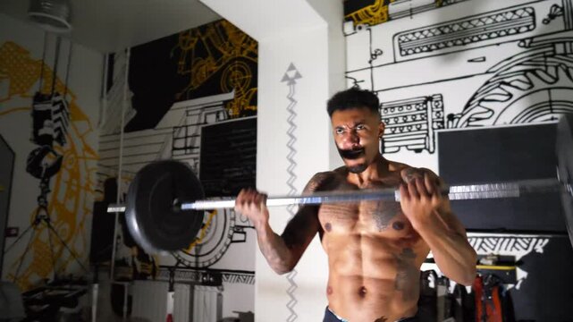Muscular afro american sportsman performing intense barbell curl exercises at modern gym. Athletic black guy doing hard workout at sport club. Sporty african man training at fitness centre. Close up